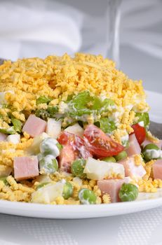 Salad of diced ham, eggs, green peas, salad leaves dressed with yogurt