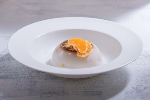 Coconut panna cotta with slices of oranges. 