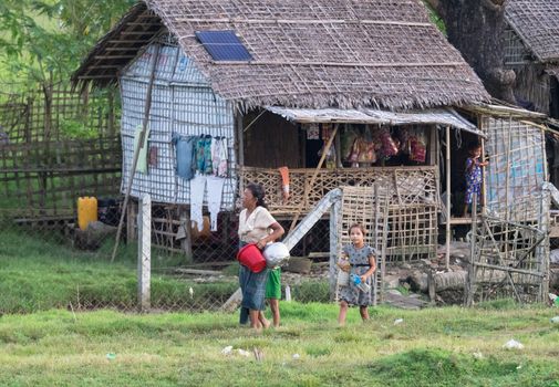Sittwe - October 25, 2016: Traditional housing with straw roof at the outskirts of Sittwe, the capital of the Rakhine State in Myanmar, a state with little development but with endless ethnic and religious conflicts.