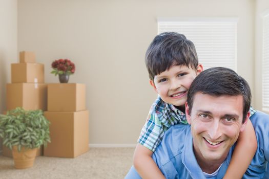 Happy Father and Son in Room with Packed Moving Boxes and Potted Plants.