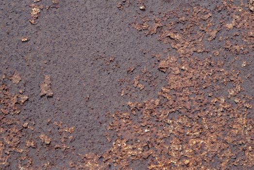 rusty iron surface covered with old chipped paint, which has long been influenced by different climatic conditions