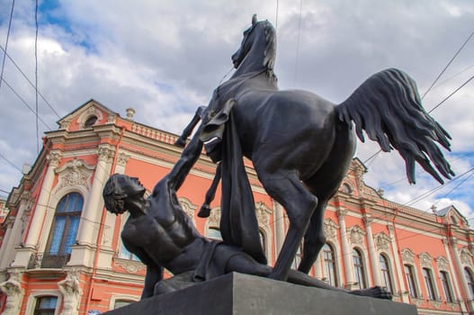 a View of Horse tamers monument by Peter Klodt on Anichkov Bridge in Saint-Petersburg Russia. Popular touristic landmark.