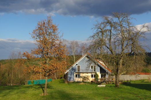 a german rural landscape with wooden house near spring forest. Black Forest in Baden Wuertemberg, Schoemberg in Germany