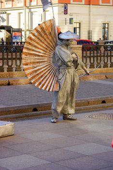 ST PETERSBURG, RUSSIA - JANUARY 01, 2016: a performer - Silver painted artists on a city street, living statues