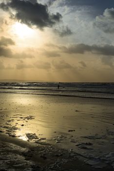 lone surfer surfing the winter waves at ballybunion beach on the wild atlantic way