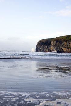 lone surfer surfing the winter waves at ballybunion beach on the wild atlantic way