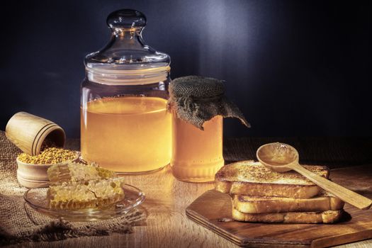 toasts and honey on the dark background