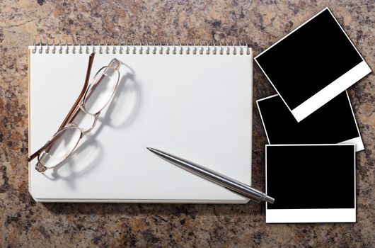Notebook with empty photograph on a granite background