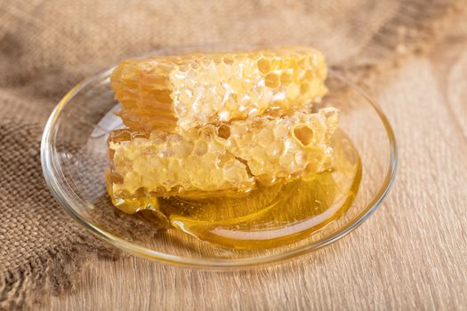 honeycomb with honey on the plate in a rustic style