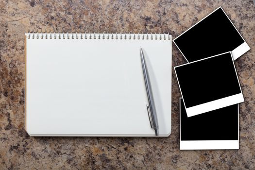 Notebook with empty photograph on a granite background
