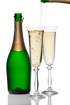 bottle and glasses of champagne on a white background