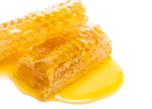 bee honeycomb with honey on a white background