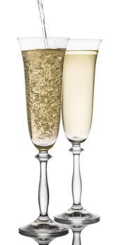 is poured into a glass champagne on white background