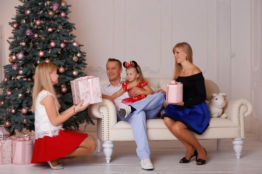 Happy father in a loving family surrounded by Christmas Eve