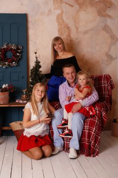 Happy father in a loving family surrounded by Christmas Eve