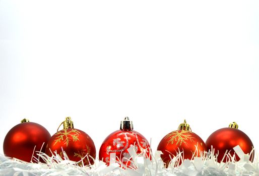Five red Christmas balls, a white wreath put horizontally down