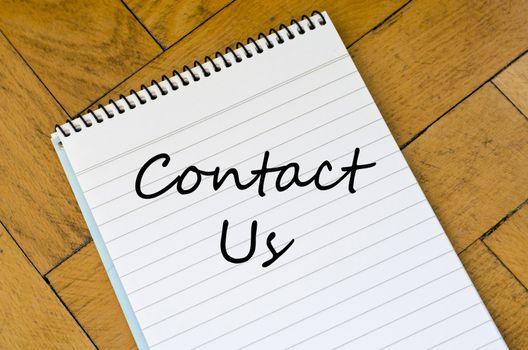 Contact us text concept write on notebook