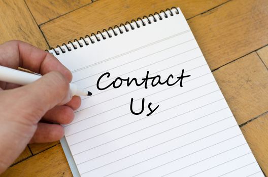 Contact us text concept write on notebook