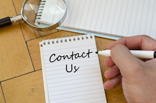 Contact us text concept write on notebook