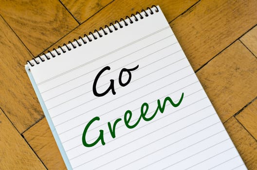 Go green text concept write on notebook