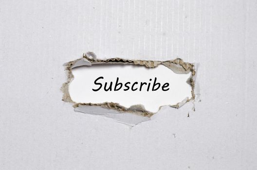 The word subscribe appearing behind torn paper