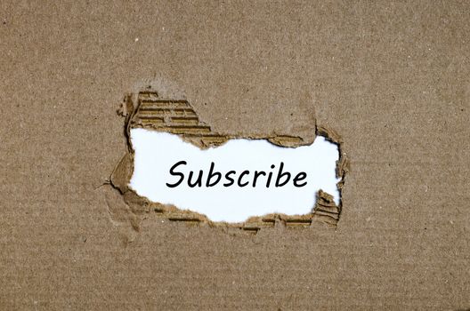 The word subscribe appearing behind torn paper