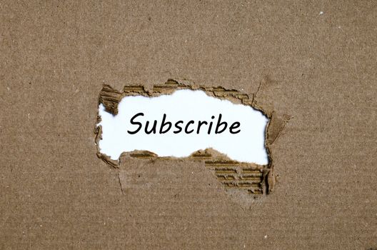 The word subscribe appearing behind torn paper