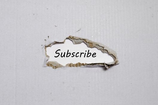 The word subscribe appearing behind torn paper