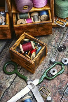 Spools of sewing threads and buttons from clothing