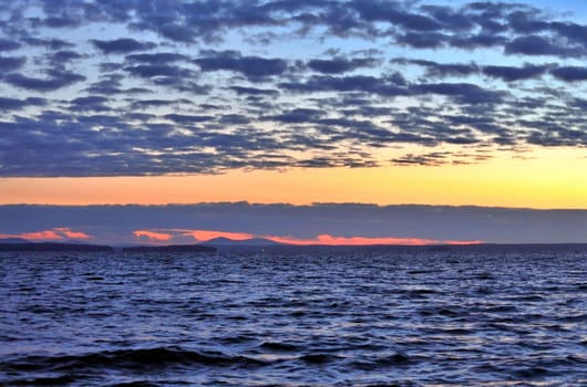 Beautiful sunrise on the lake in windy weather