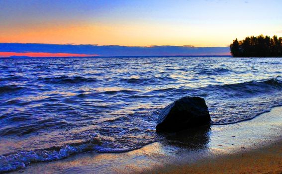 Beautiful sunrise on the lake in windy weather