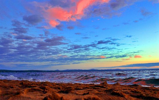 Beautiful sunrise on the lake in windy weather