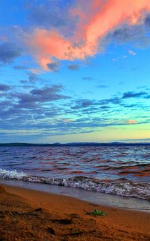 Beautiful sunrise on the lake in windy weather
