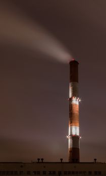 Smoke stack against sky at night