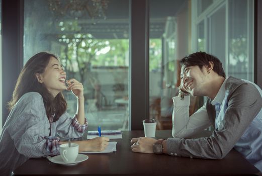 couples of younger asian man and woman relaxing with hot coffee drink in coffee shop happiness feeling