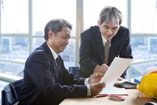 partner of senior engineering working man serious meeting about project discussing solution shot on table in office meeting room