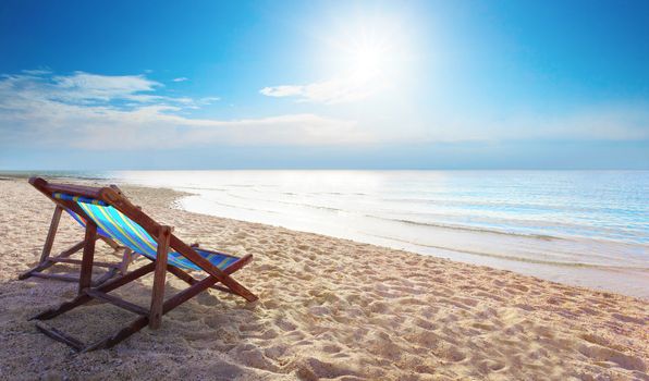 couples of wood chair beach and blue sky at sea side for summer vacation 