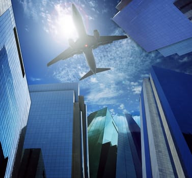 plane flying over skyscraper