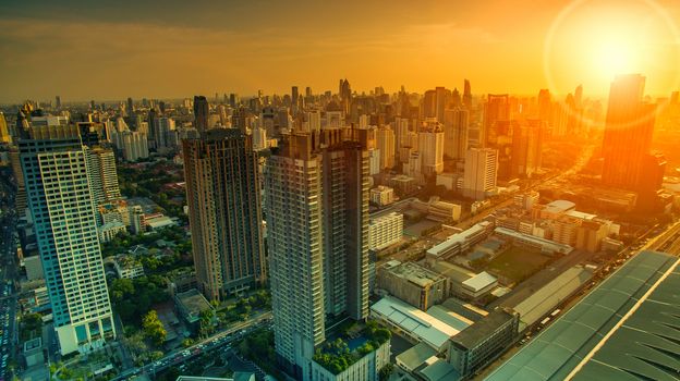 aerial view of sky scraper in heart of bangkok thailand capital with beautiful sun light over sky