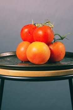 Red ripe fresh tomatoes on a metal baking tray.