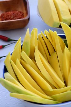 Vietnamese fruit, green mango cut in slice, a popular tropical fruit, rich vitamin A, vitamin C, collagen, good for health and impulse calcium absorption