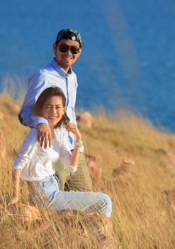 portrait of asian younger man and woman relaxing vacation at sea side happiness emotion