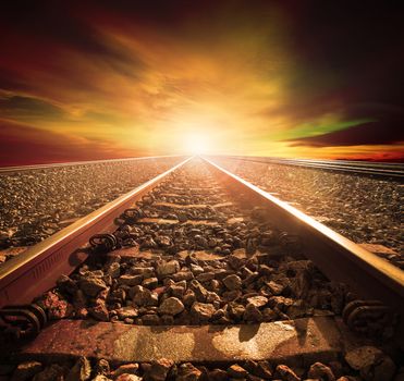junction of railways track in trains station agains beautiful light of sun set sky use for land transport and logistic industry background ,backdrop,copy space theme