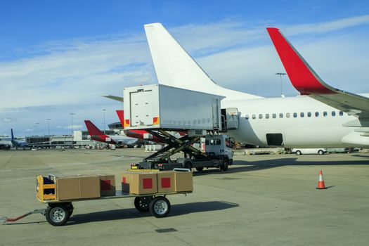 cargo plane loading commercial product in airport 