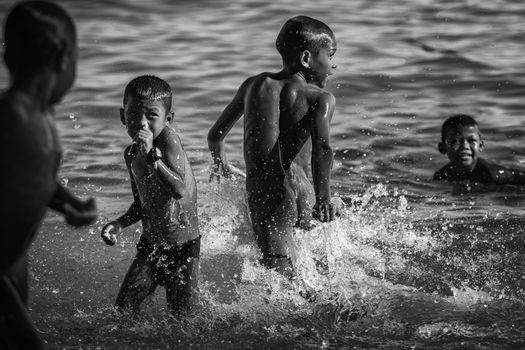 asian children playing at sea beach