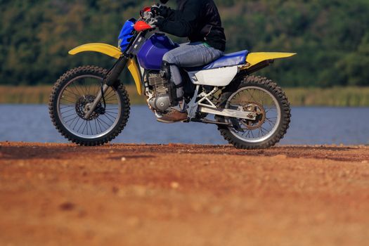 man riding enduro motorcycle on dirt field