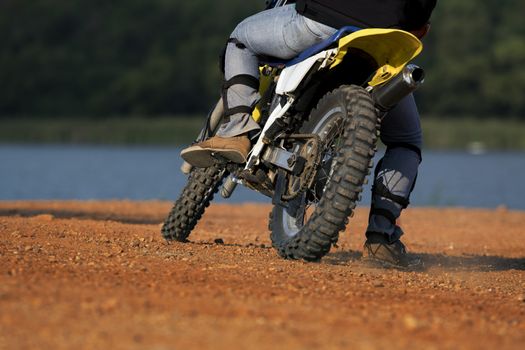 man riding enduro motorcycle on dirt field