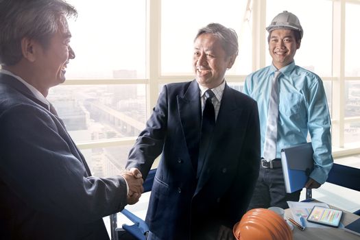 business man shaking hand after successful project solution planing meeting shot in office meeting room