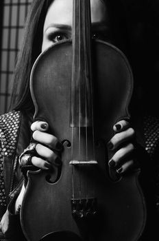 beautiful girl touch violin in the hands