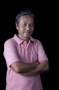 portrait close up smiling happiness face of 59s years old asian man with studio light against black background